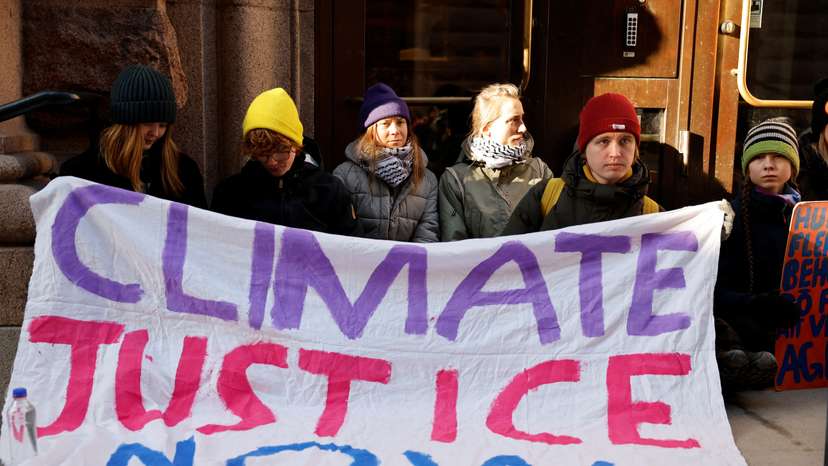 Climate activist Greta Thunberg blocks the entrance of the Swedish Parliament during a protest in Stockholm