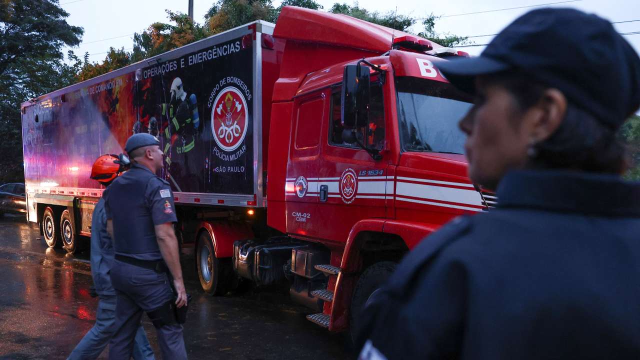 Authorities arrive at the site where a turboprop plane crashed near Sao Paulo