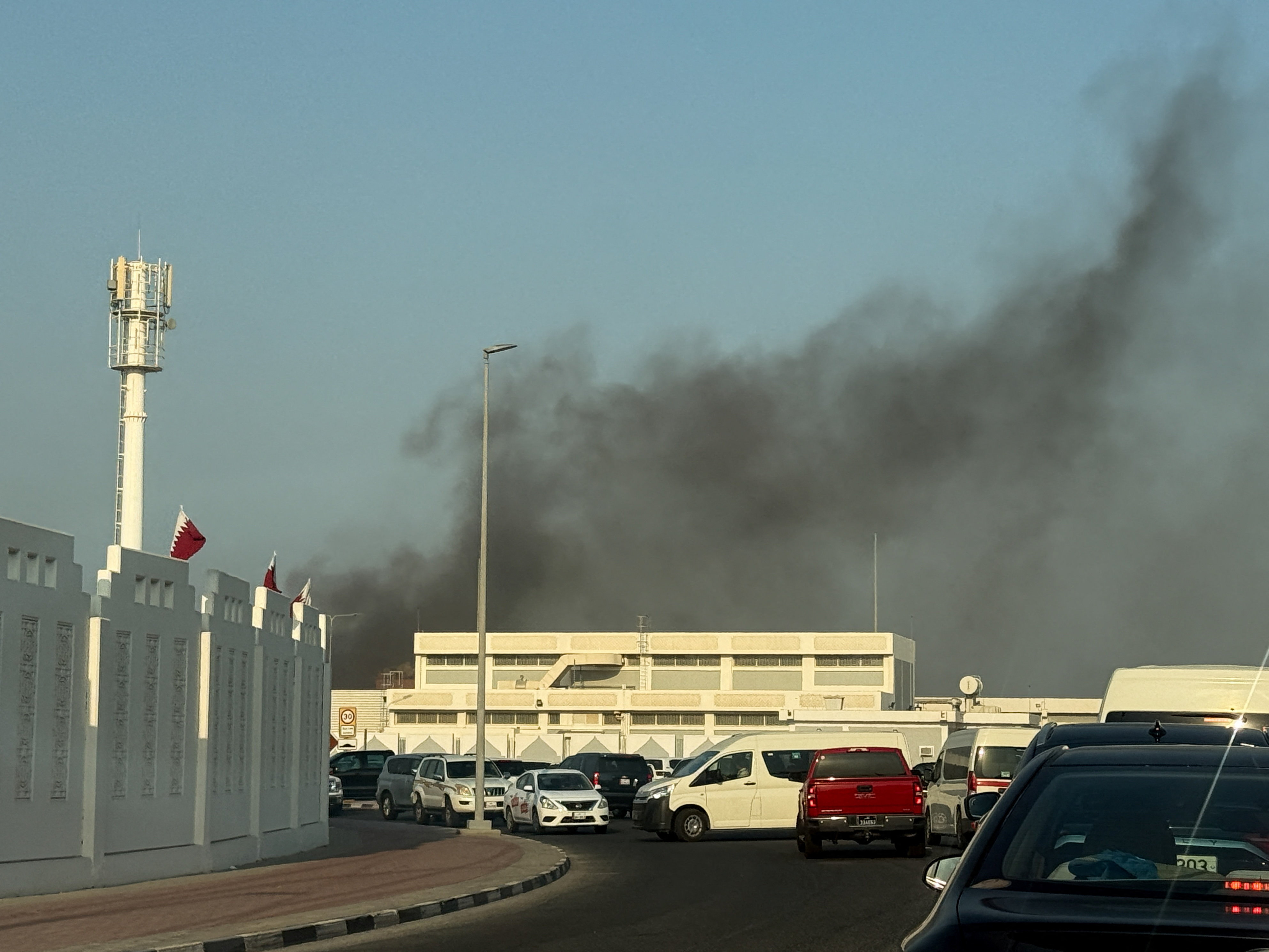 Smoke rises after several blasts were heard in Doha