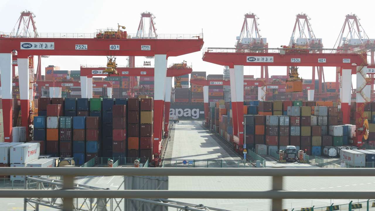 Gantry cranes stand near shipping containers at Yangshan Port outside of Shanghai