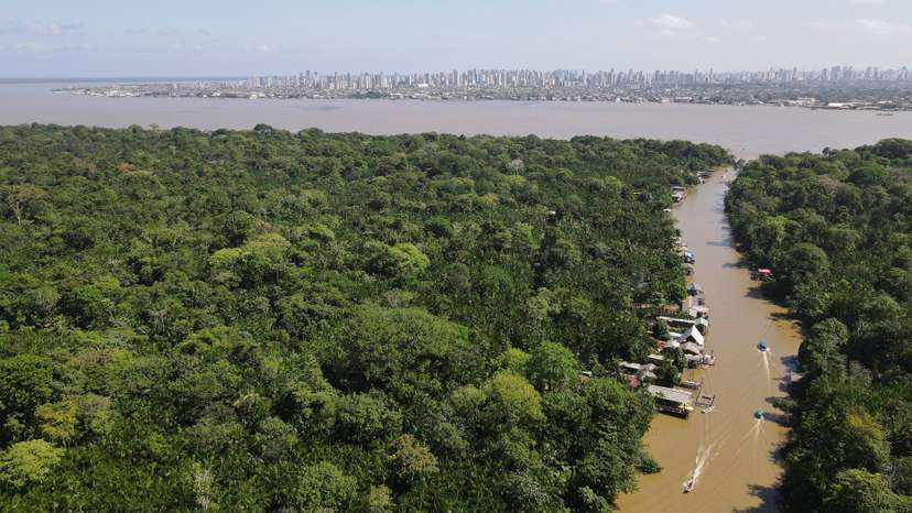 FILE PHOTO: A drone image shows the Amazon rainforest and the city of Belém in the back ahead of COP 30, at Ilha do Combu, in Belem