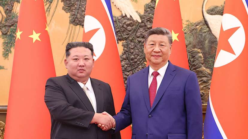 Chinese President Xi Jinping and DPRK leader Kim Jong Un shake hands in Beijing