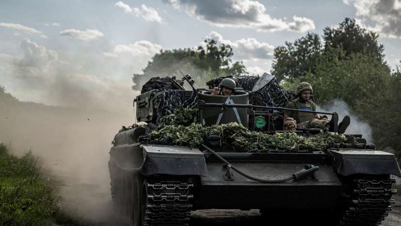 FILE PHOTO: Ukrainian servicemen ride a military vehicle near the Russian border in Sumy region