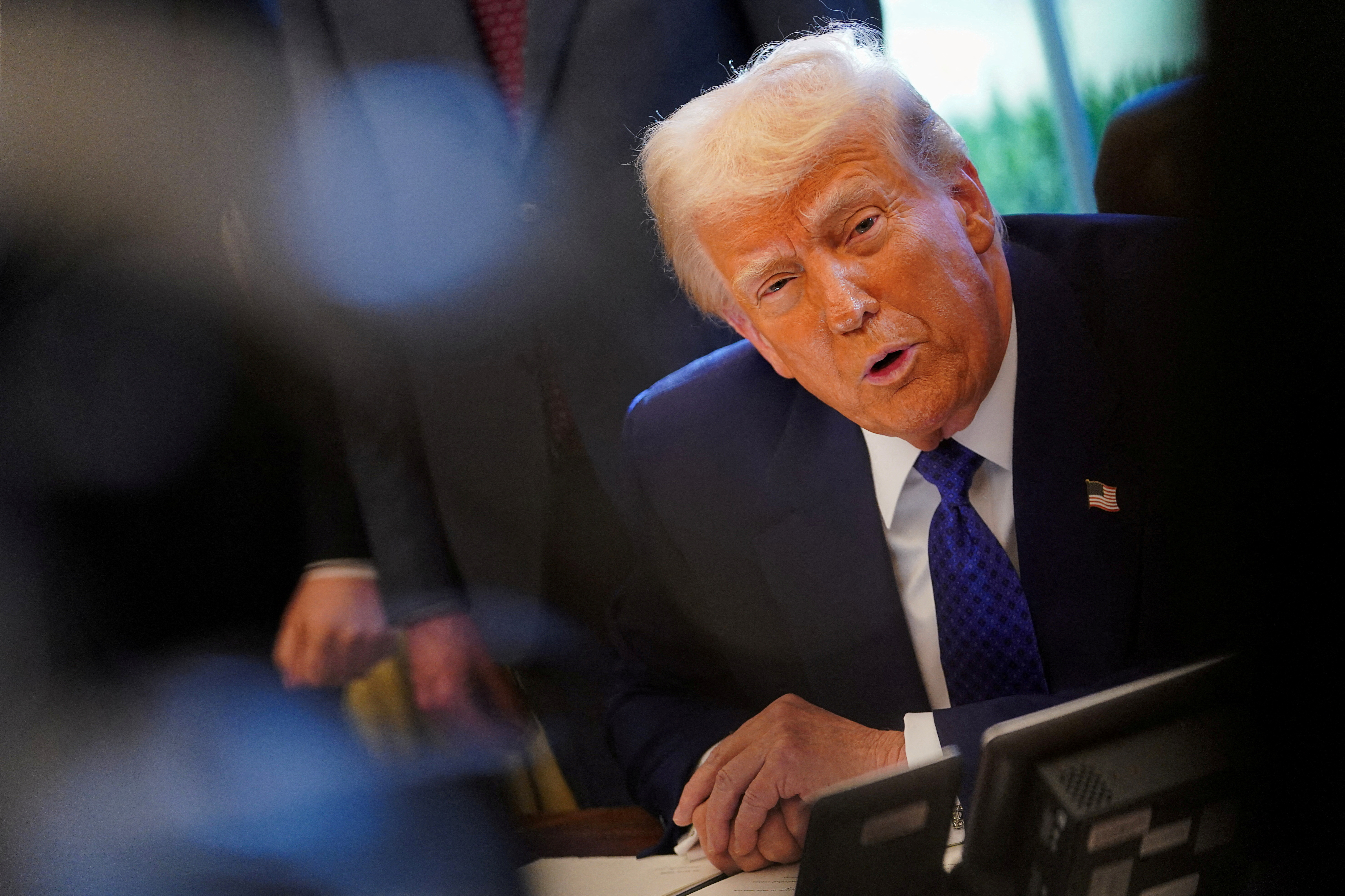 FILE PHOTO: U.S. President Donald Trump signs an executive order in the Oval Office at the White House in Washington, D.C.