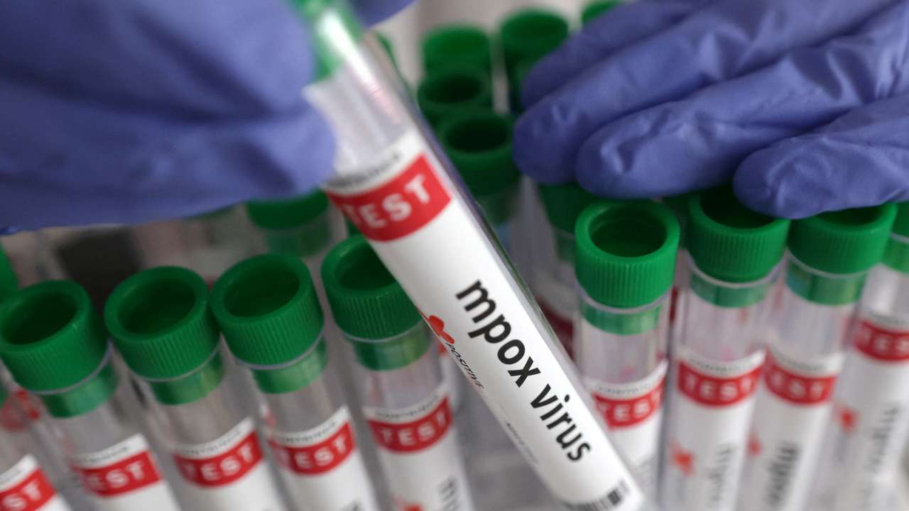 Illustration shows test tubes with "Mpox virus positive" label
