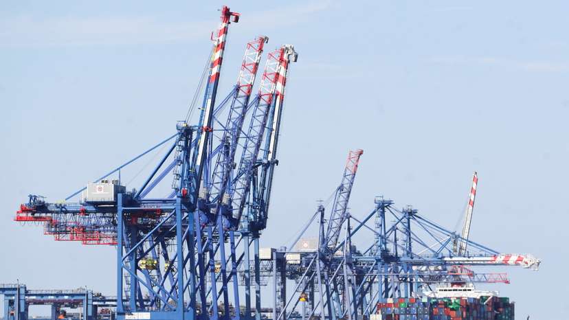 A container ship is seen beside cranes at the Suez canal near Ismailia port city, northeast of Cairo