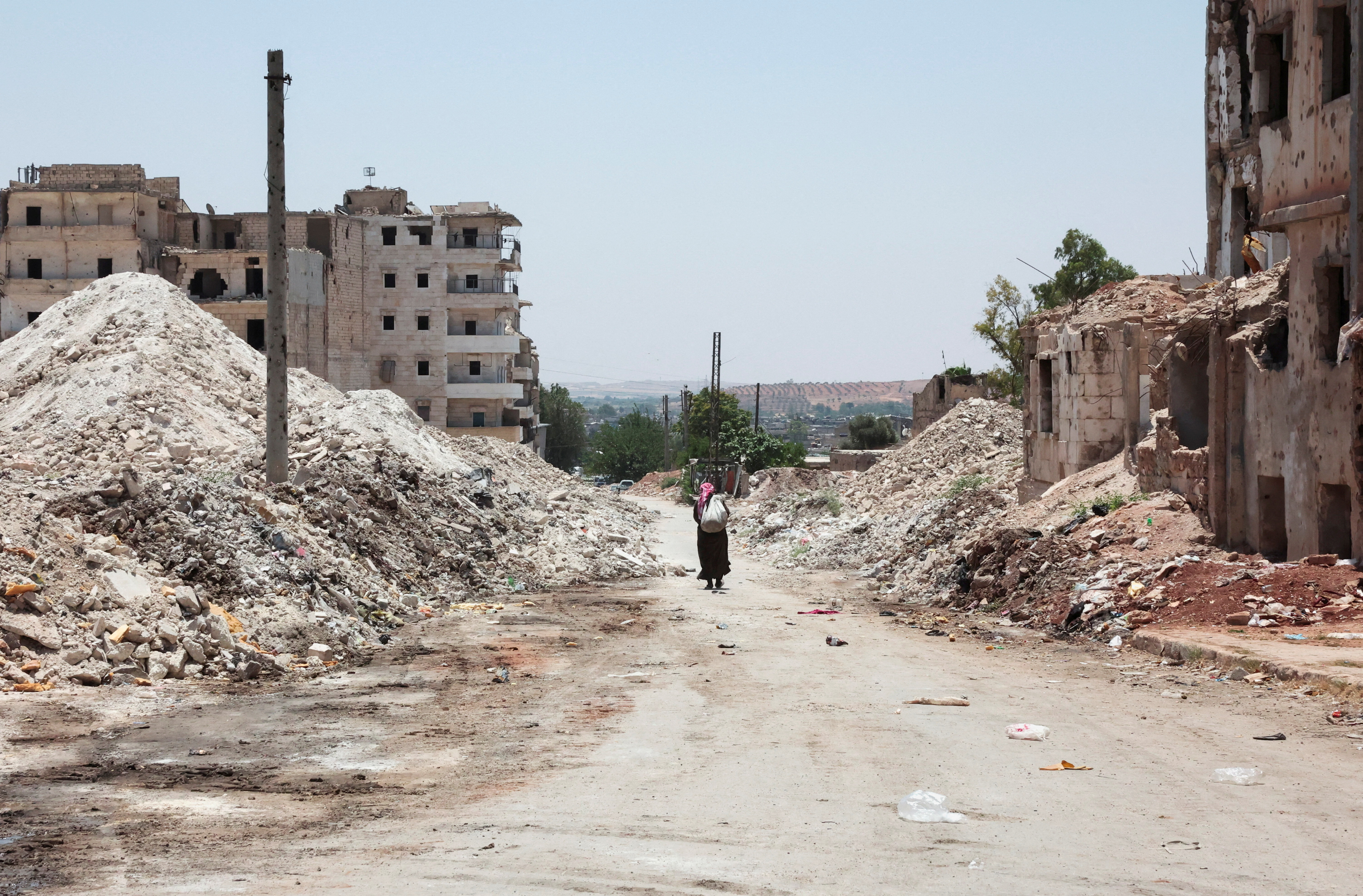 A man walks through the destruction in the city of Aleppo