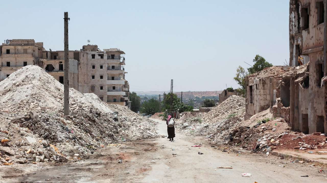 A man walks through the destruction in the city of Aleppo