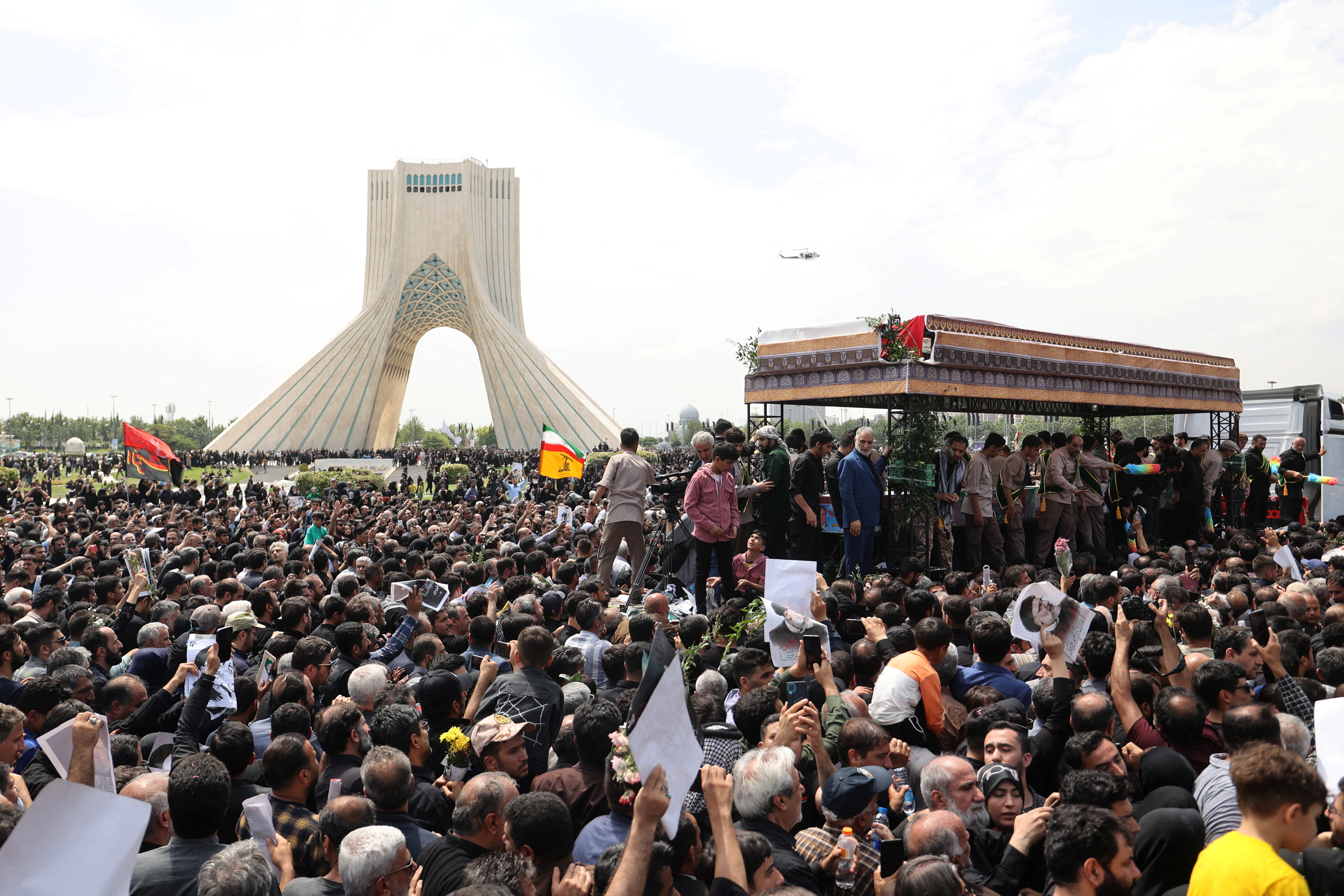 Mourners attend a funeral for victims of the helicopter crash that killed Iran's President Ebrahim Raisi, in Tehran
