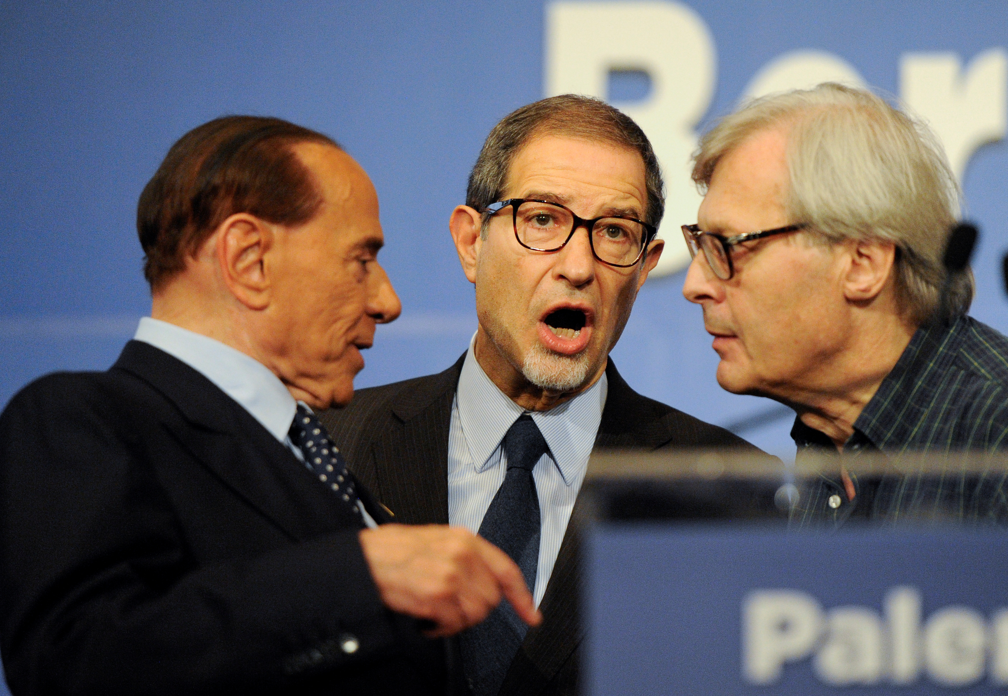 Forza Italia party leader Silvio Berlusconi talks to candidate Nello Musumeci and Vittorio Sgarbi at the end of a rally for the regional election in Palermo