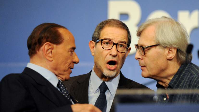 Forza Italia party leader Silvio Berlusconi talks to candidate Nello Musumeci and Vittorio Sgarbi at the end of a rally for the regional election in Palermo