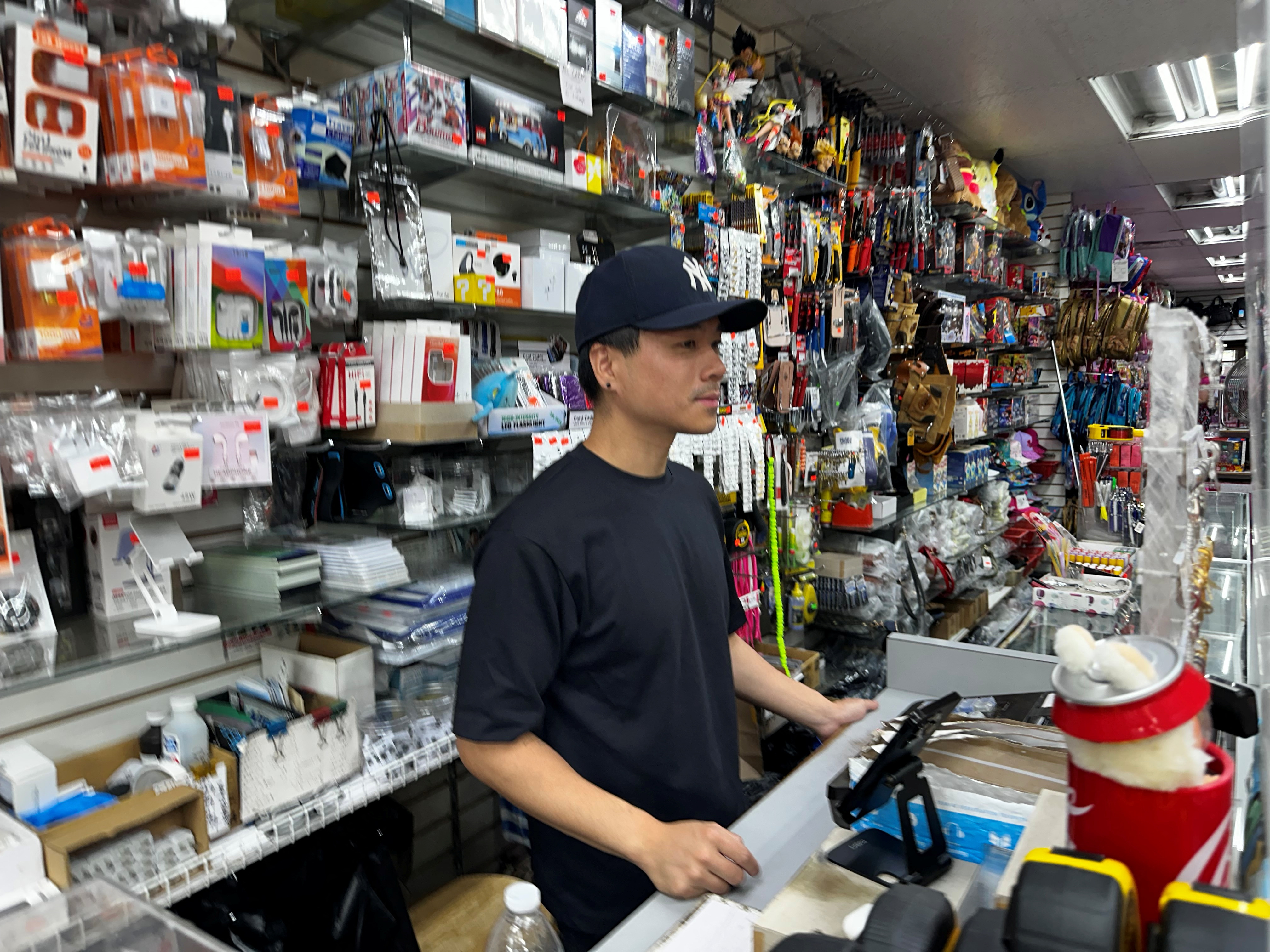 S. Shan mans the cash register of his family's store, the Tien Rong Gift Shop, in the heavily Latino Ironbound section of Newark