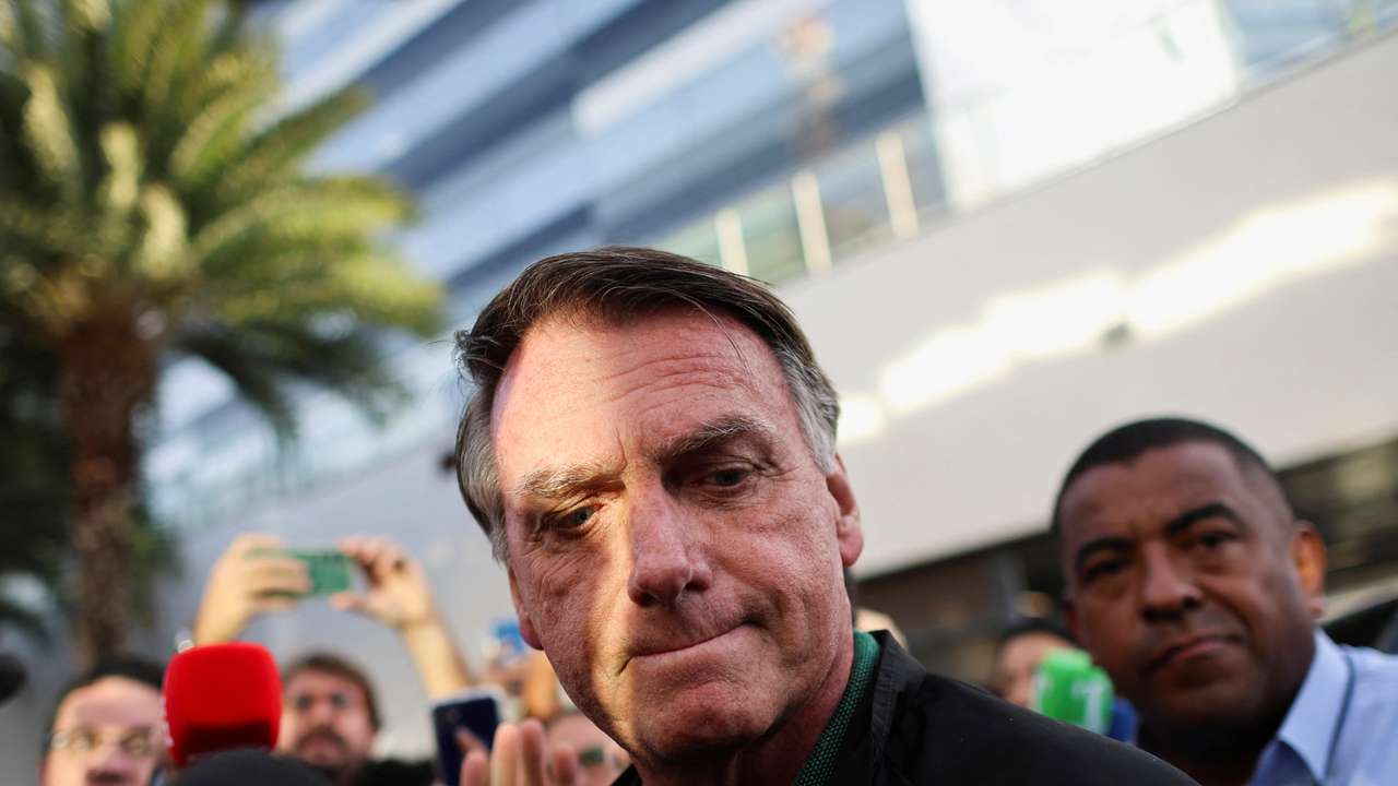 Former Brazilian President Jair Bolsonaro reacts as he leaves the Federal Police headquarters after testifying, in Brasilia