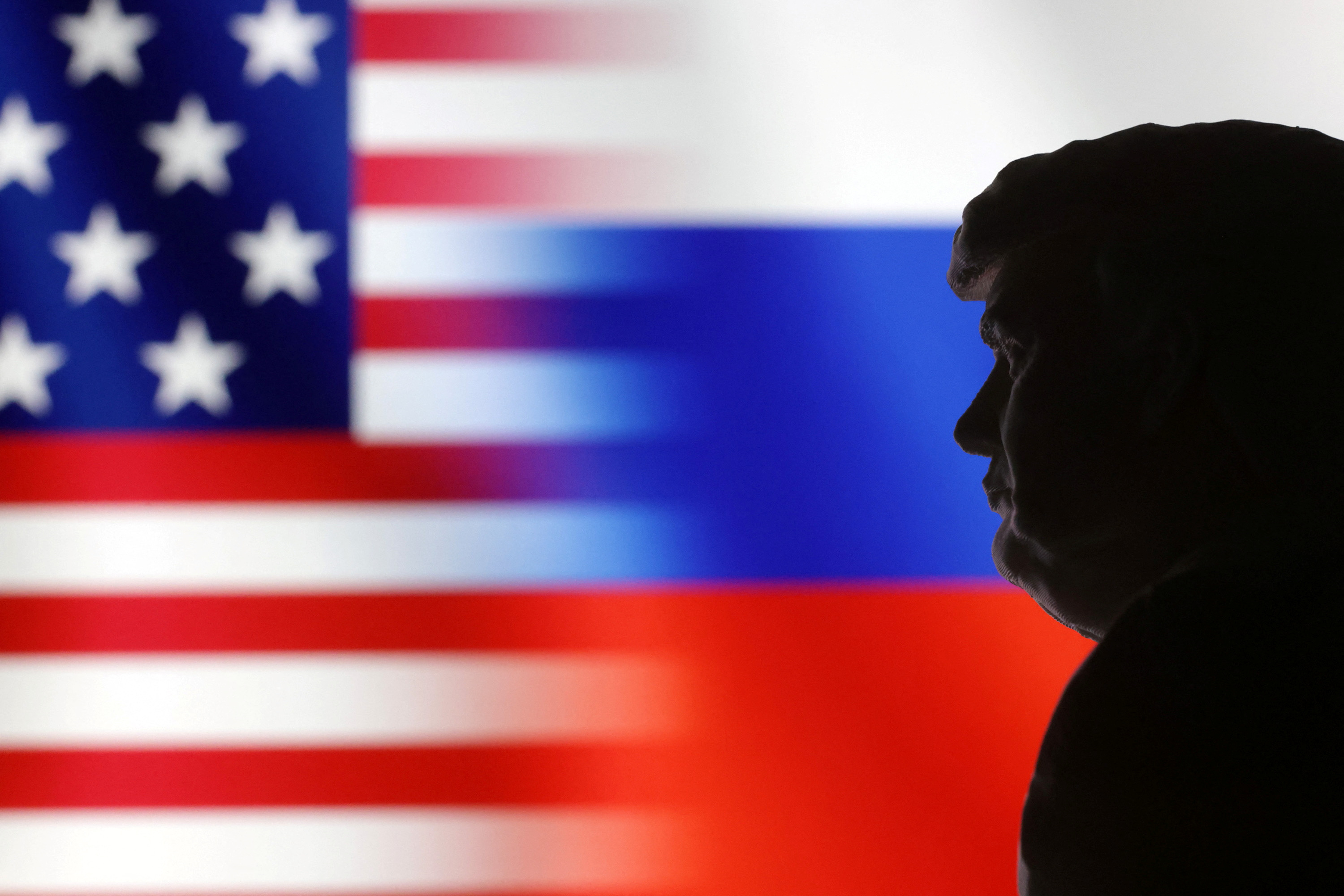 Illustration shows 3D-printed Donald Trump miniature model, and U.S. and Russian flags
