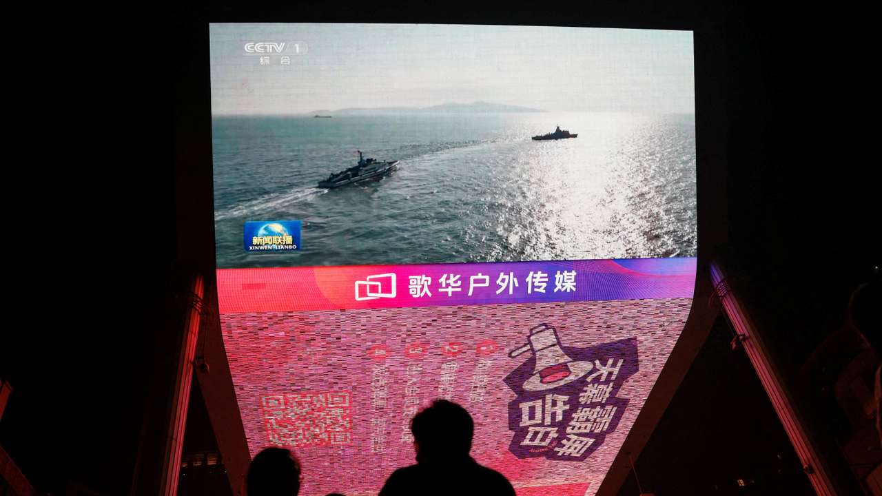 FILE PHOTO: Screen shows news footage of military drills conducted in areas around the island of Taiwan by the Eastern Theatre Command of the Chinese PLA, in Beijing