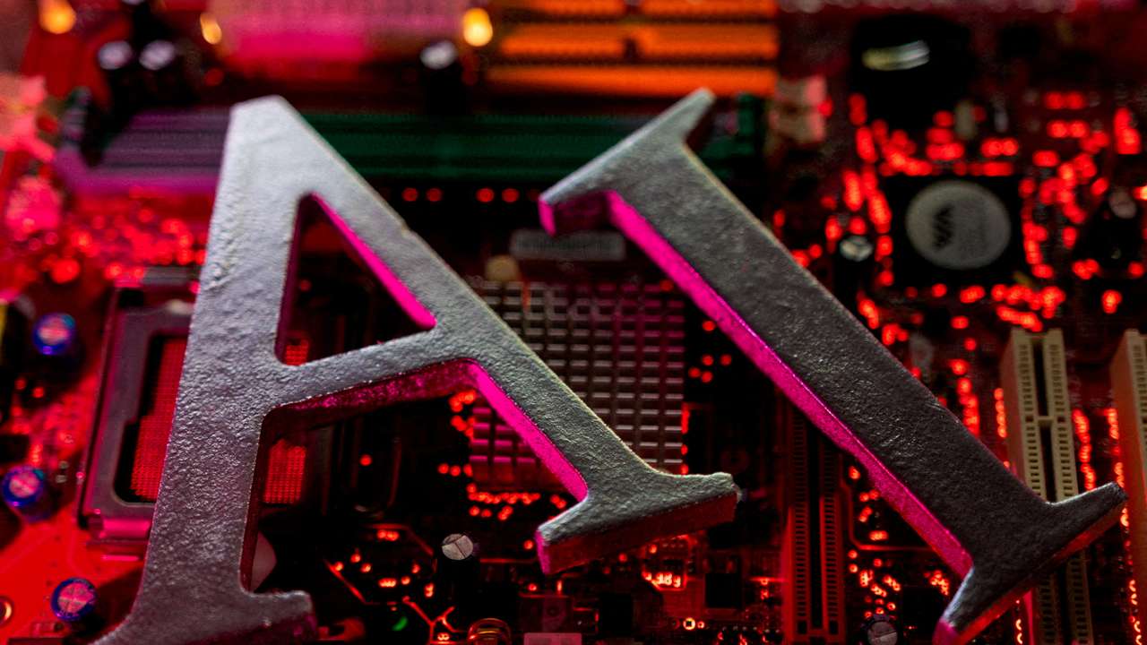 FILE PHOTO: Illustration shows AI (Artificial Intelligence) letters and computer motherboard