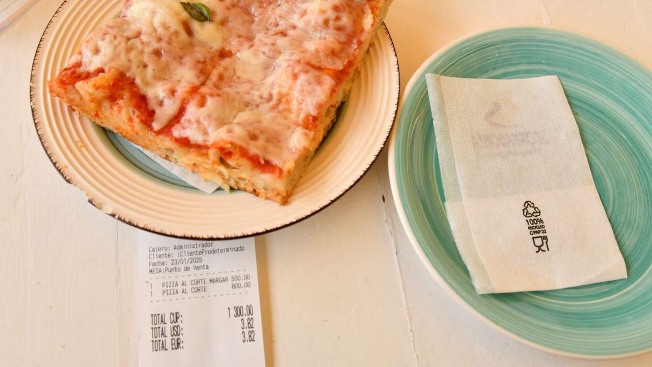 A picture illustration shows a restaurant ticket displaying the bill in Cuban pesos, U.S. dollars and euros