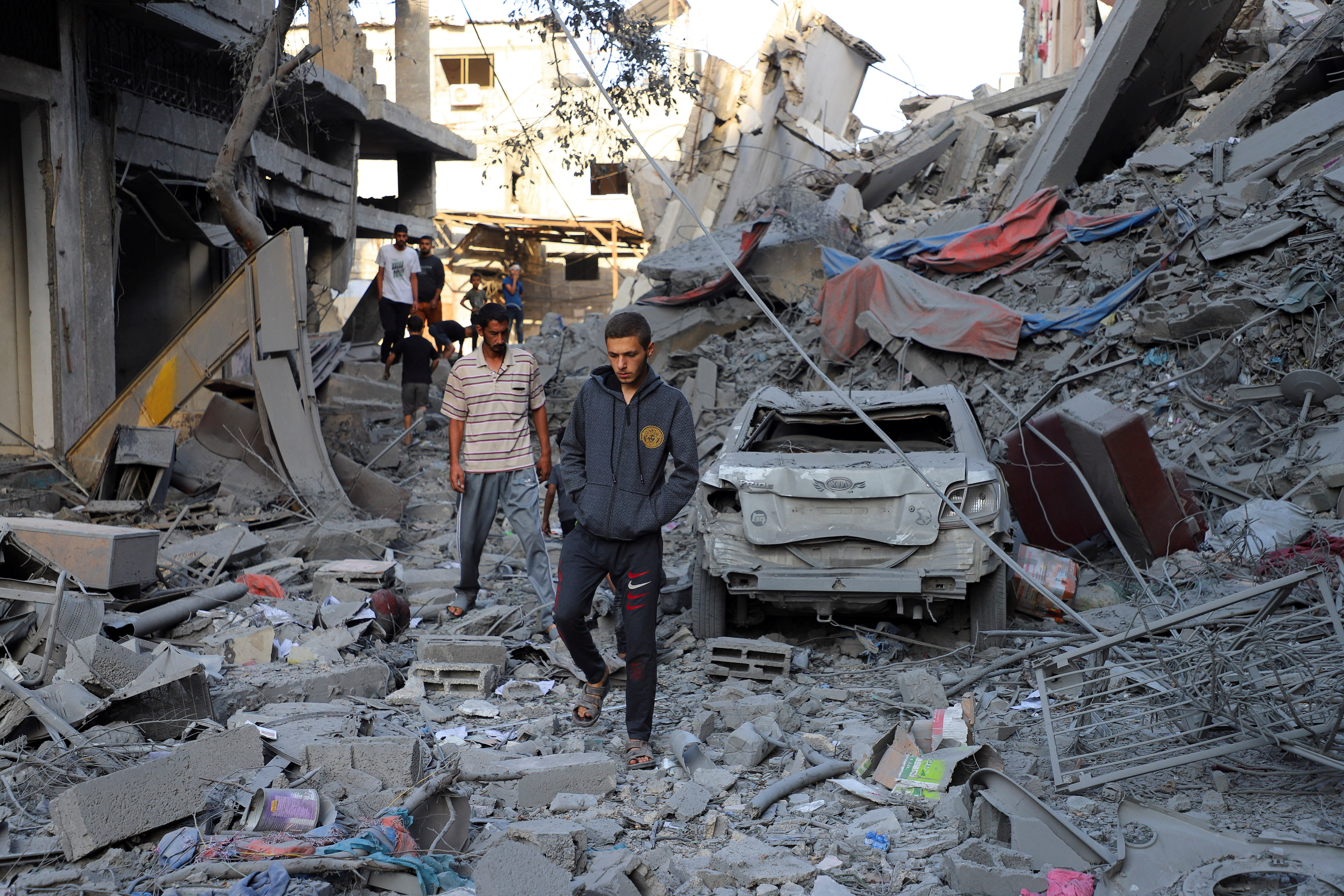 Palestinians inspect the site of Israeli strikes on houses at Shati (Beach) refugee camp in Gaza City