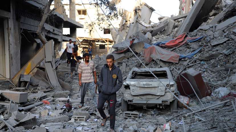 Palestinians inspect the site of Israeli strikes on houses at Shati (Beach) refugee camp in Gaza City
