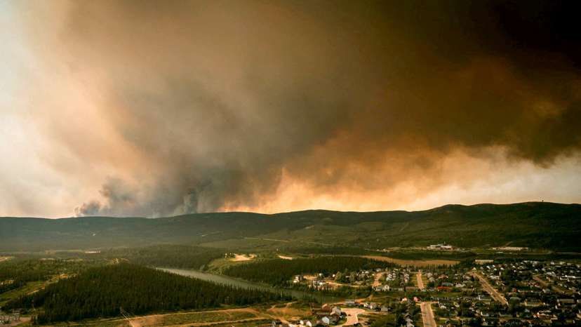 FILE PHOTO: Smoke from an encroaching wildfire is seen over homes after an evacuation was ordered in the eastern Canadian community of Labrador City