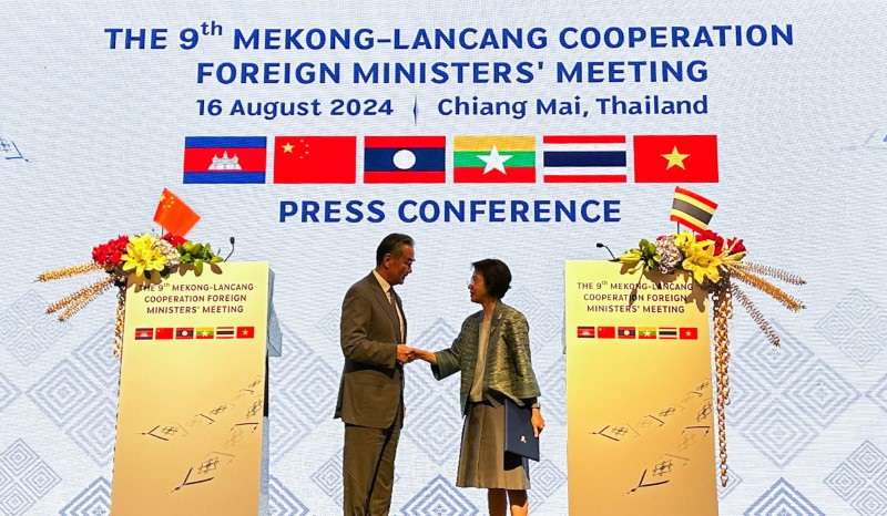 China's Foreign Minister Wang Yi shakes hand with Eksiri Pintaruchi, Permanent Secretary for Foreign Affairs of Thailand, during the 9th Mekong-Lancang Cooperation Foreign Ministers' Meeting in Chiang Mai