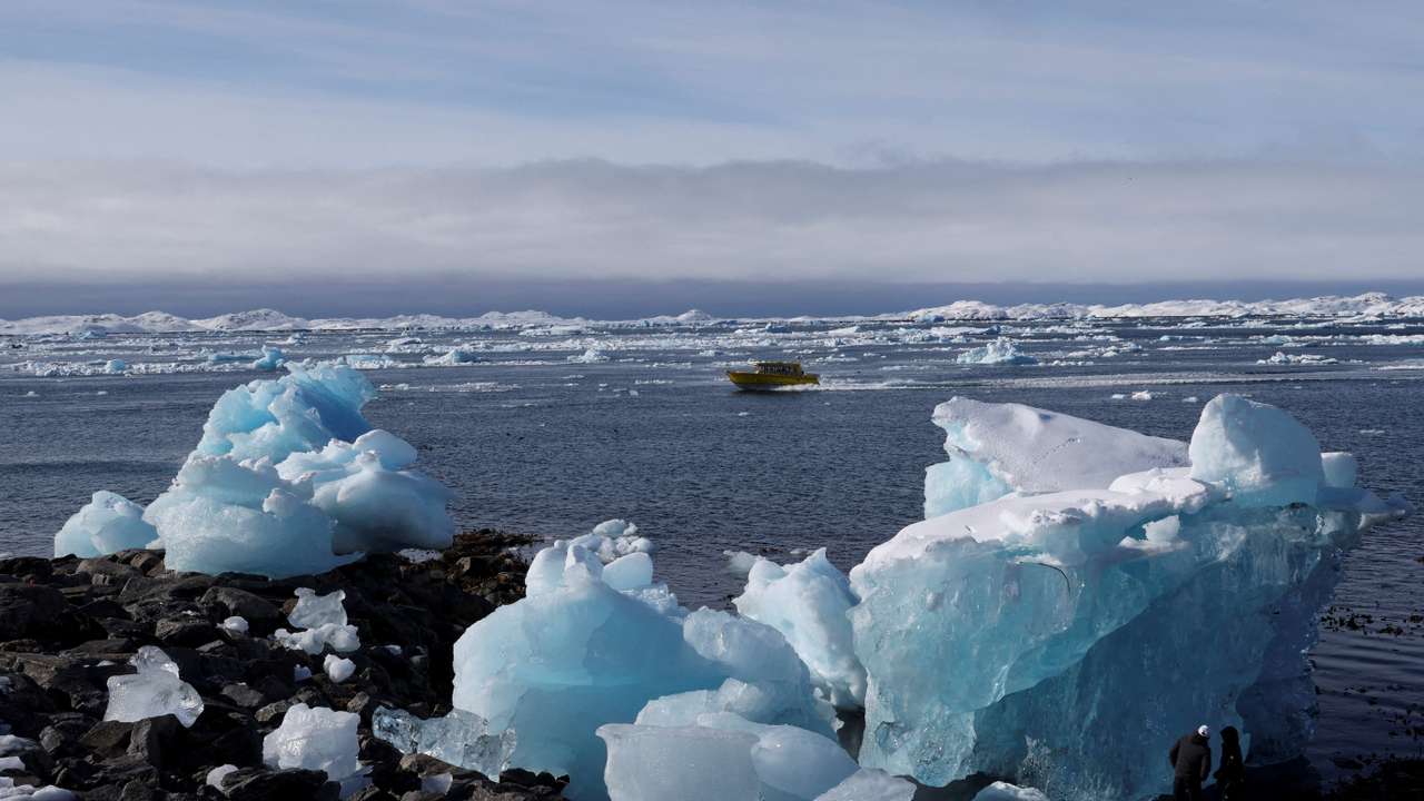 FILE PHOTO: A tourist boat passes chunks of ice in the fjord of Greenland's capital Nuuk