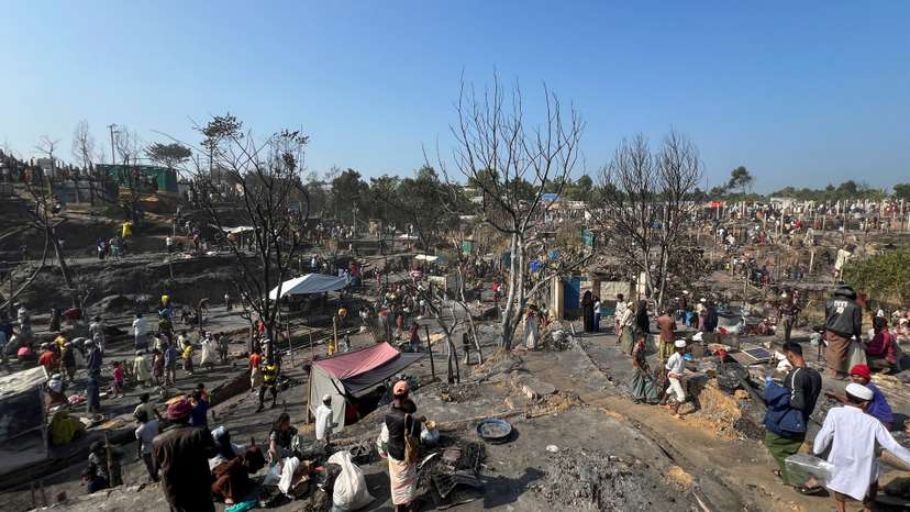 Rohingya refugees work on rebuilding their makeshift shelters after a fire broke out in a camp in Cox's Bazar