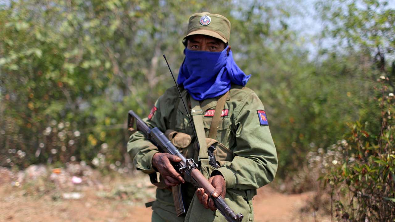 FILE PHOTO: A rebel soldier of the Myanmar National Democratic Alliance Army (MNDAA) holds his rifle as he guards near a military base in Kokang region