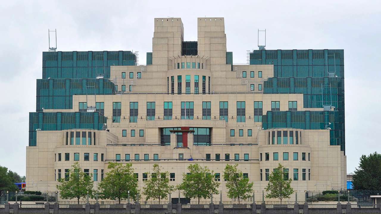 A motorboat passes by the MI6 building in London
