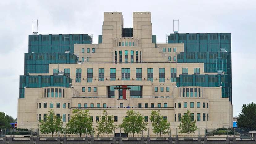 A motorboat passes by the MI6 building in London
