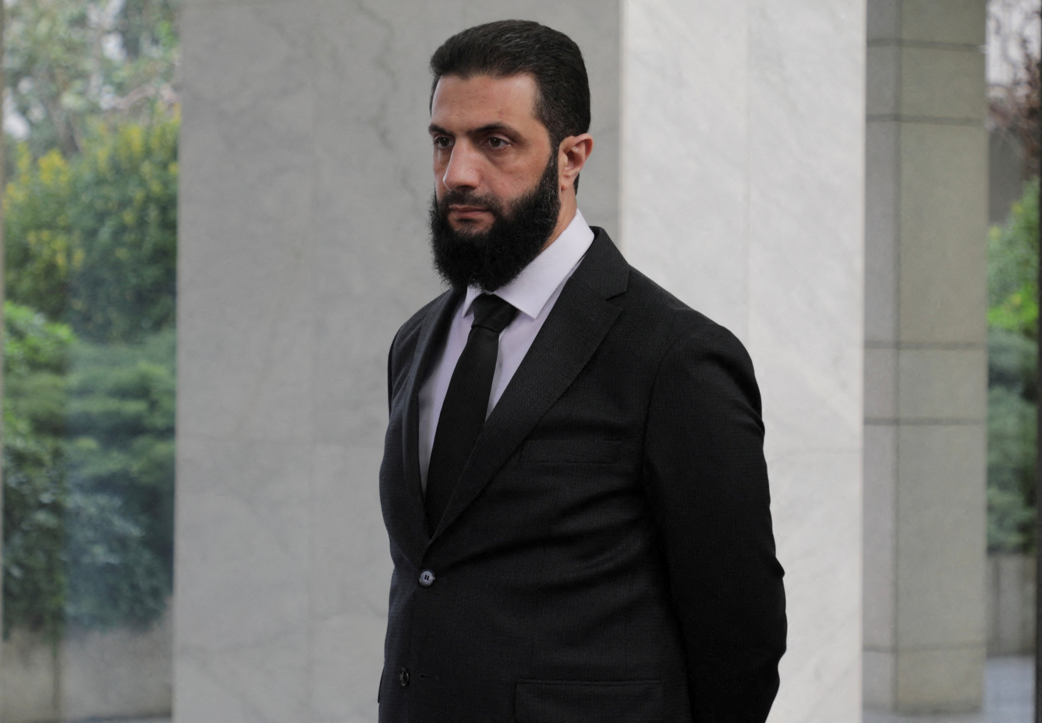 FILE PHOTO: Syria's de facto leader Ahmed al-Sharaa, also known as Abu Mohammed al-Golani waits to welcome the senior Ukrainian delegation led by Ukrainian Foreign Minister Andrii Sybiha, after the ousting of Syria's Bashar al-Assad, in Damascus