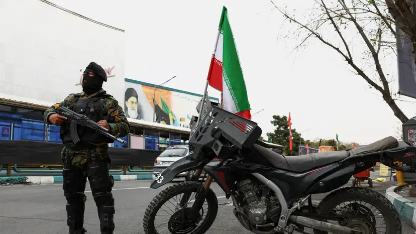 A member of a police force stands guard on a street, amid the U.S.-Israeli conflict with Iran, in Tehran