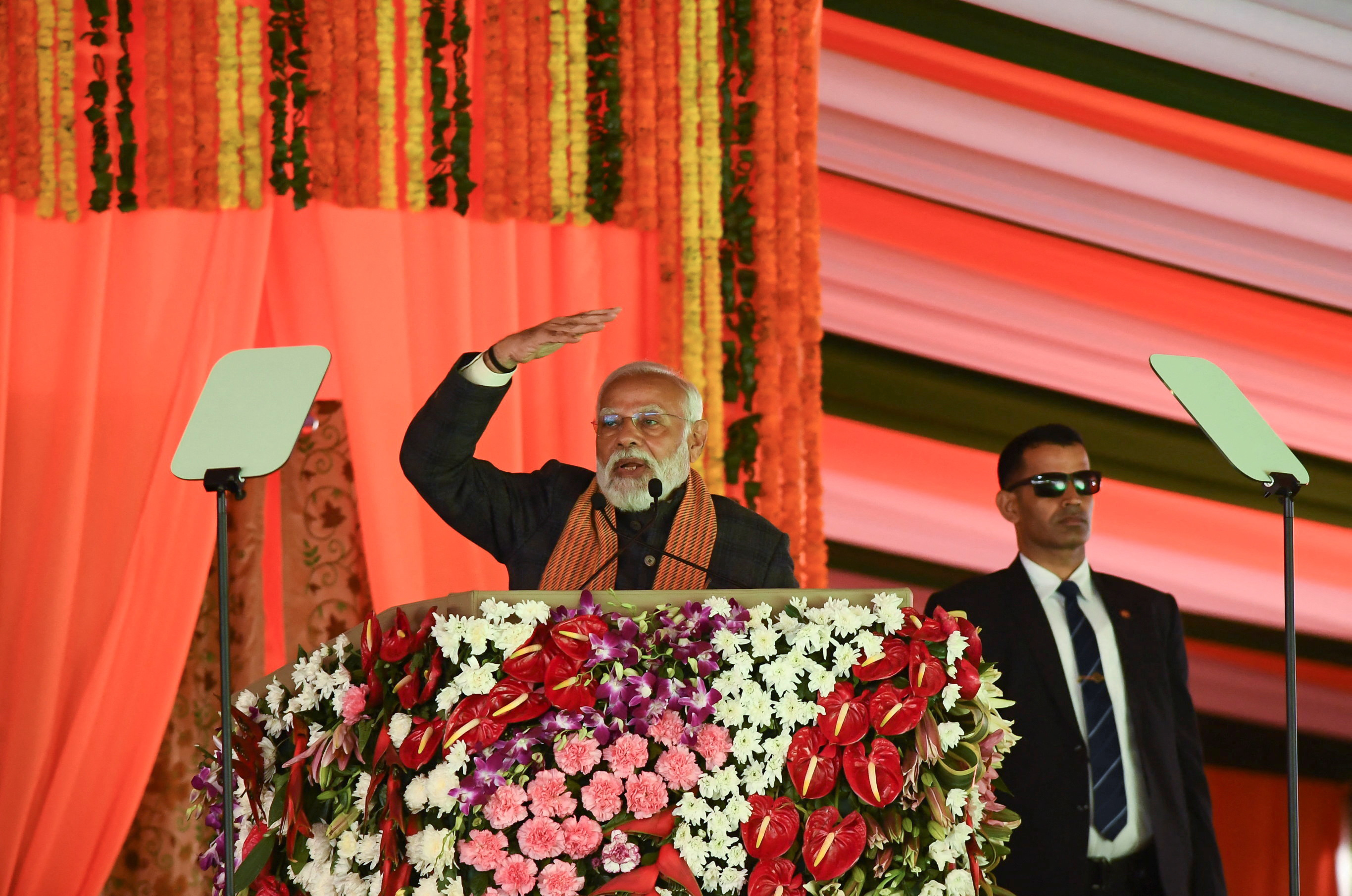 India’s Prime Minister Narendra Modi speaks during a rally, as his bodyguard looks on at the Bakshi Stadium in Srinagar