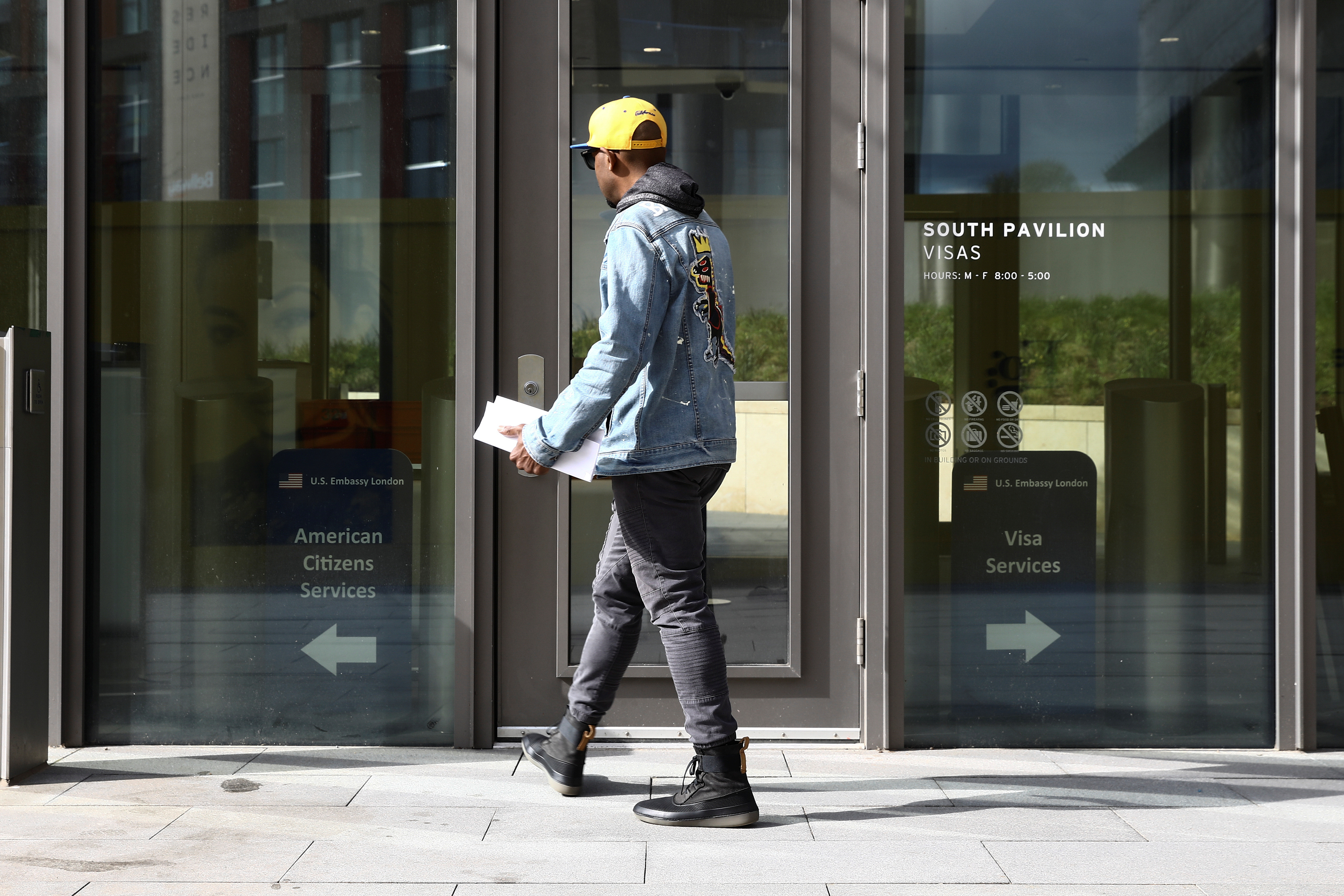 A visitor tries to enter the visa section of the U.S. Embassy  in Nine Elms in London