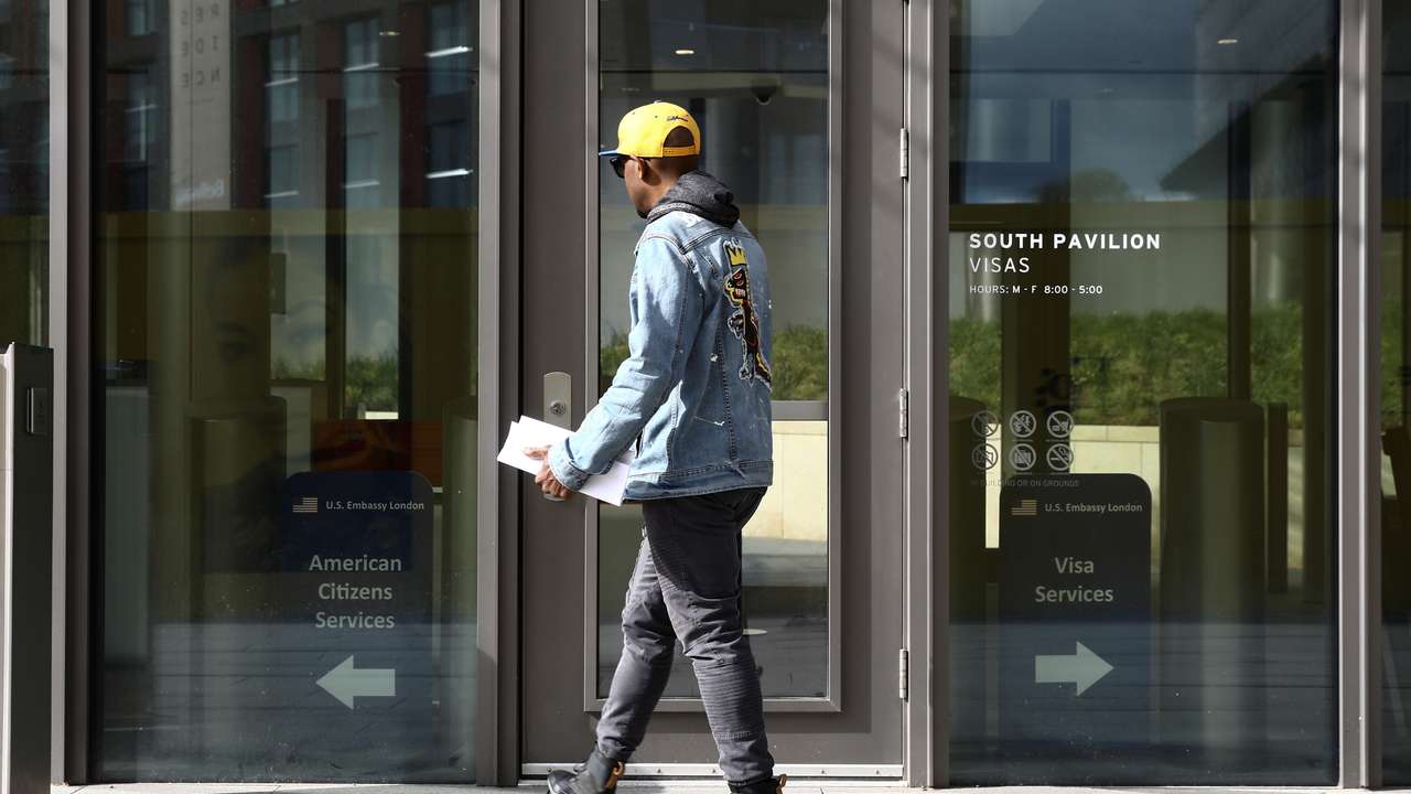 A visitor tries to enter the visa section of the U.S. Embassy in Nine Elms in London