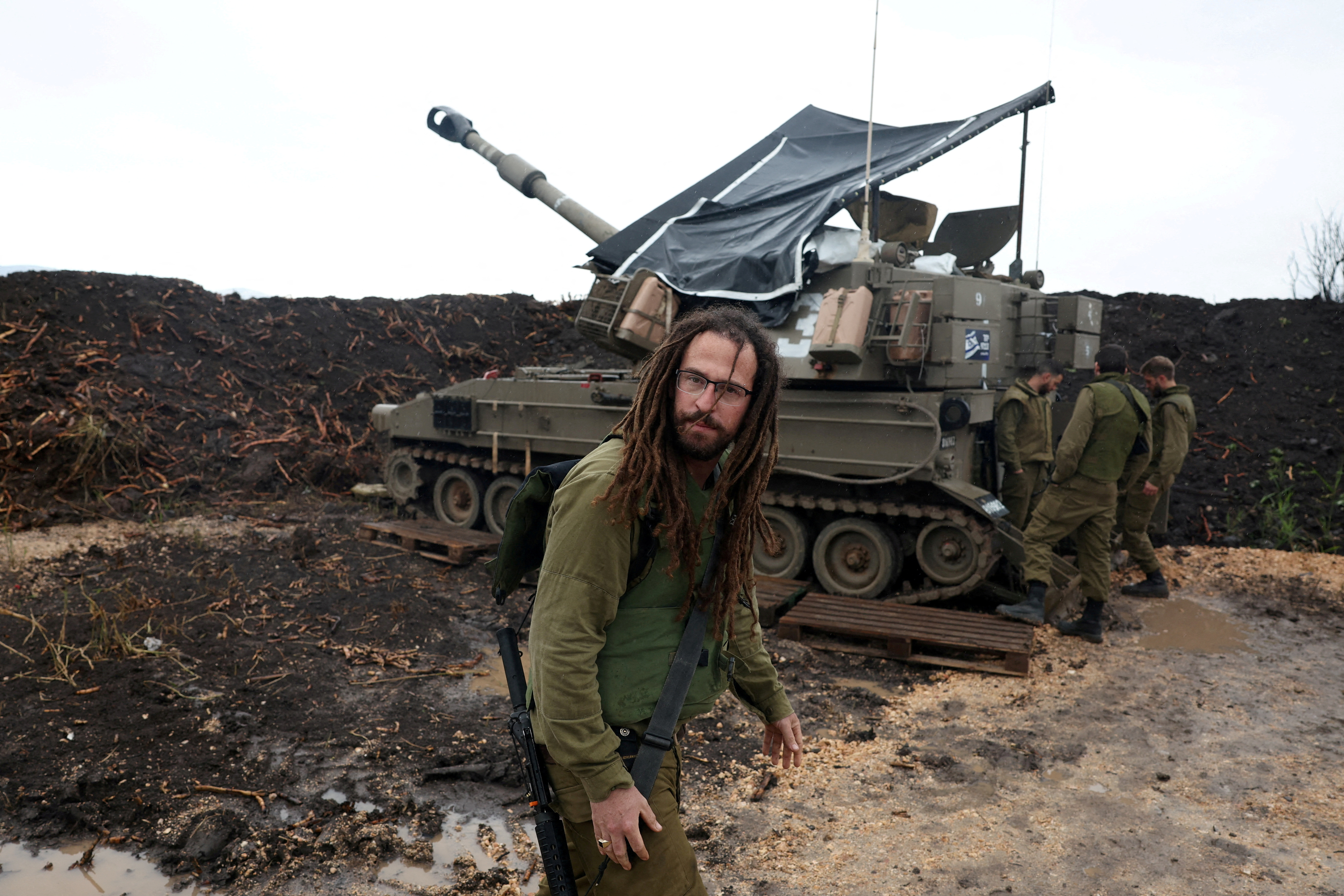 FILE PHOTO: Israeli soldiers stand by near the Israel-Lebanon border