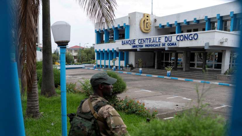 FILE PHOTO: FILE PHOTO: A member of the M23 rebel group stands guard at Congo's Central Bank, in Goma