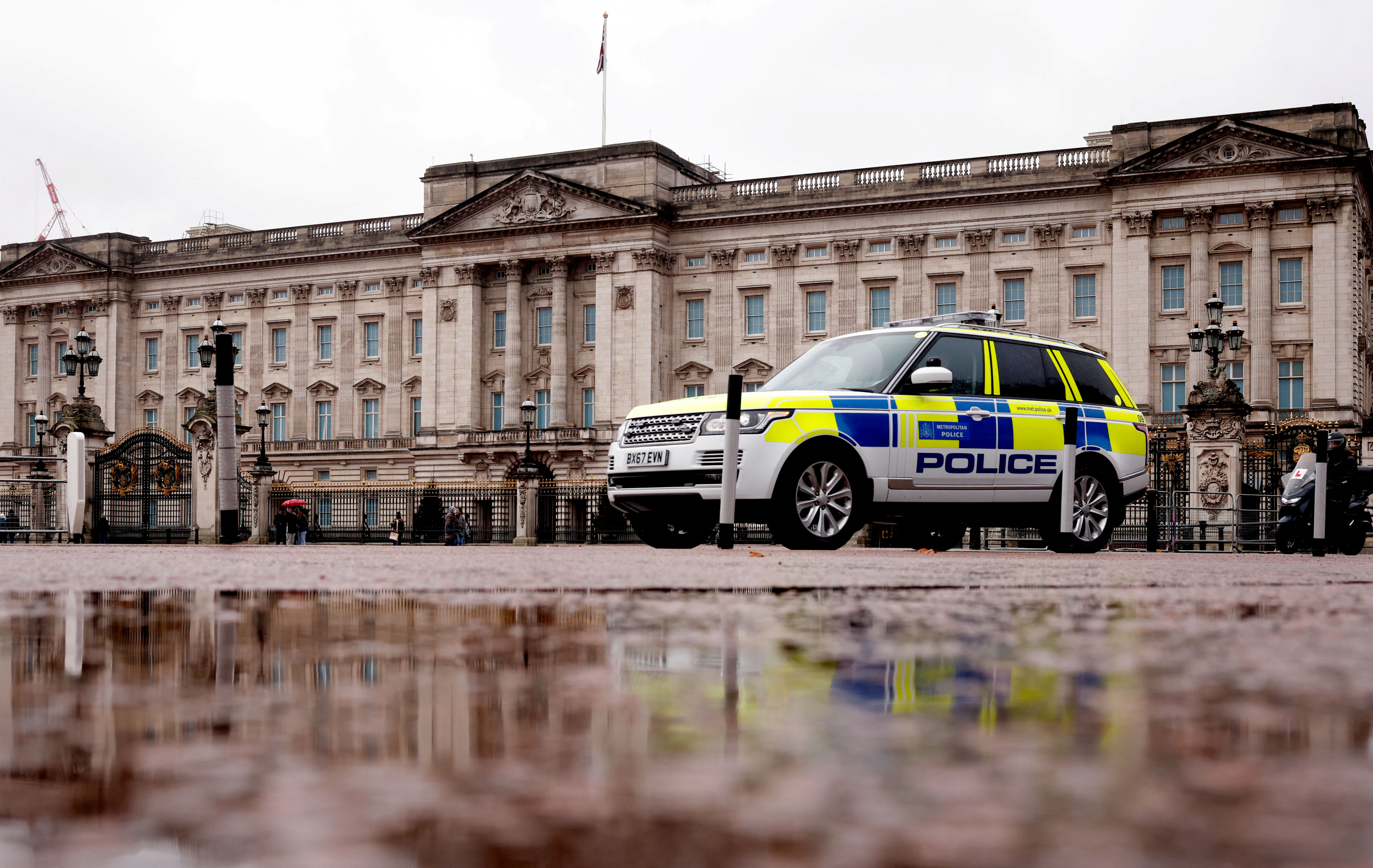 A police vehicle drives past Buckingham Palace in London