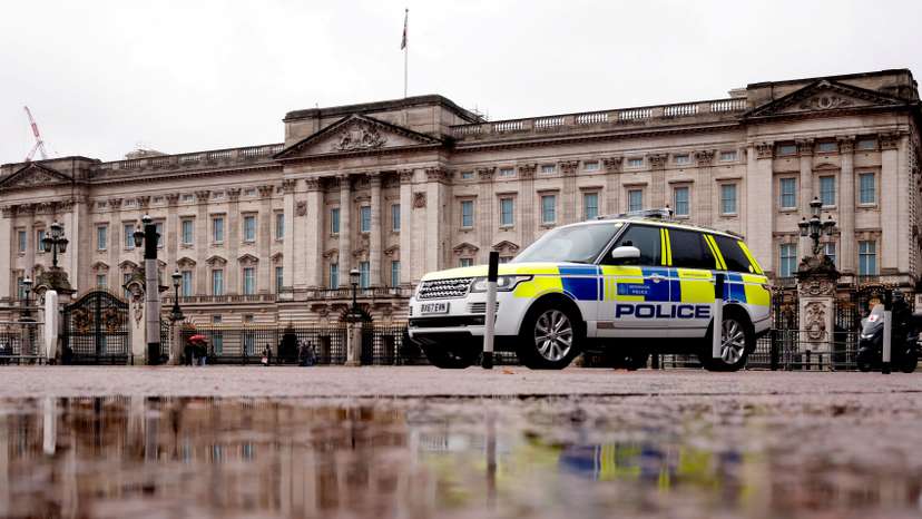 A police vehicle drives past Buckingham Palace in London