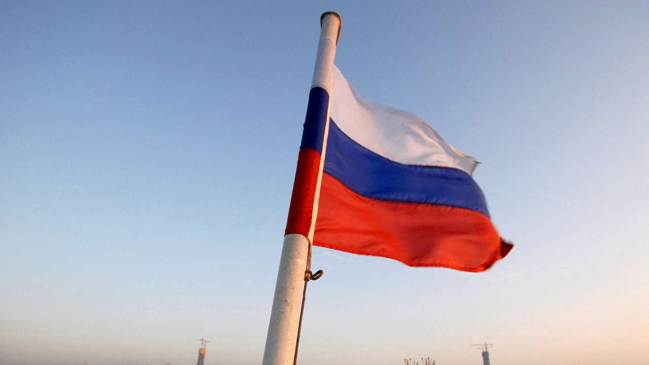 FILE PHOTO: The Russian national flag flies on a vessel moving along the strait of East Bosphorus in Vladivostok