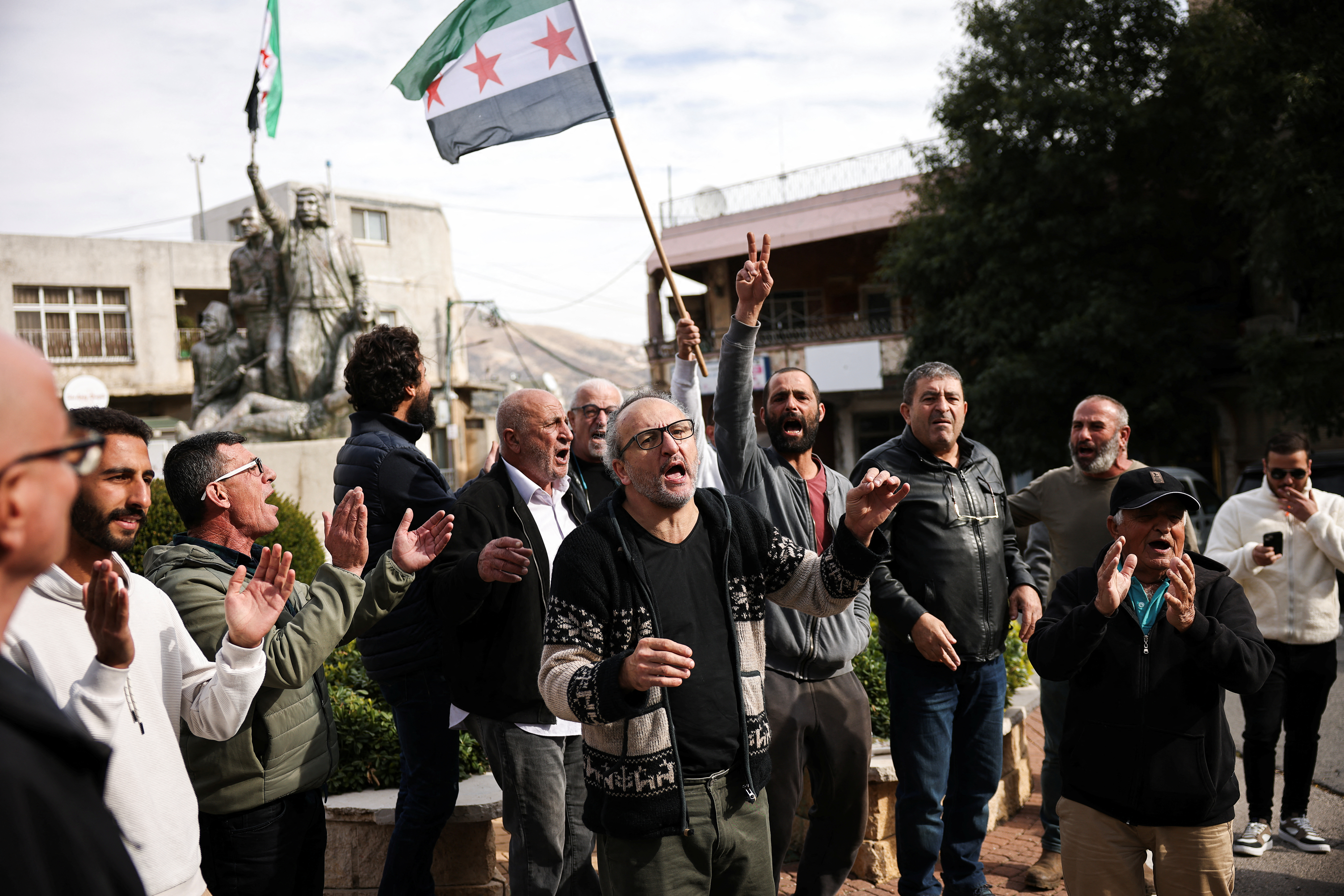 People celebrate, after Syrian rebels announced that they have ousted President Bashar al-Assad, in Majdal Shams