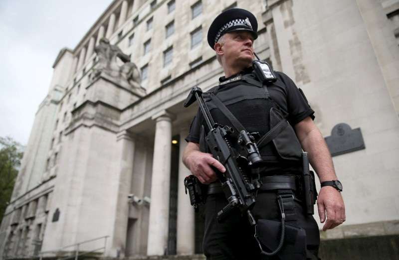 FILE PHOTO: An armed police officer patrols near the Ministry of Defence in London