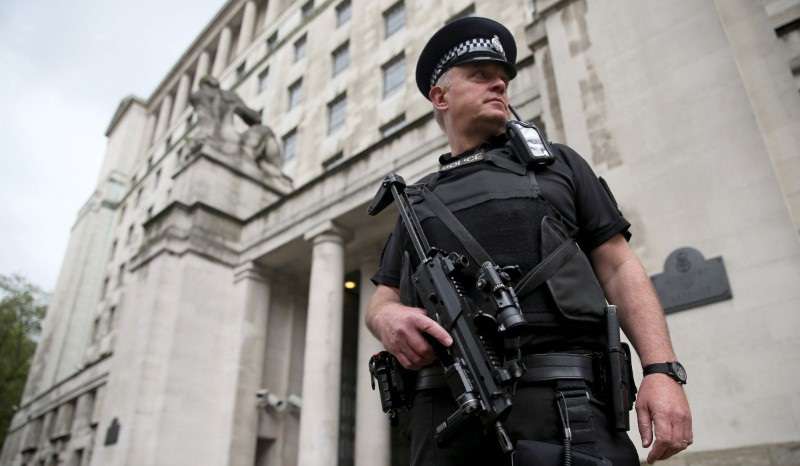 FILE PHOTO: An armed police officer patrols near the Ministry of Defence in London