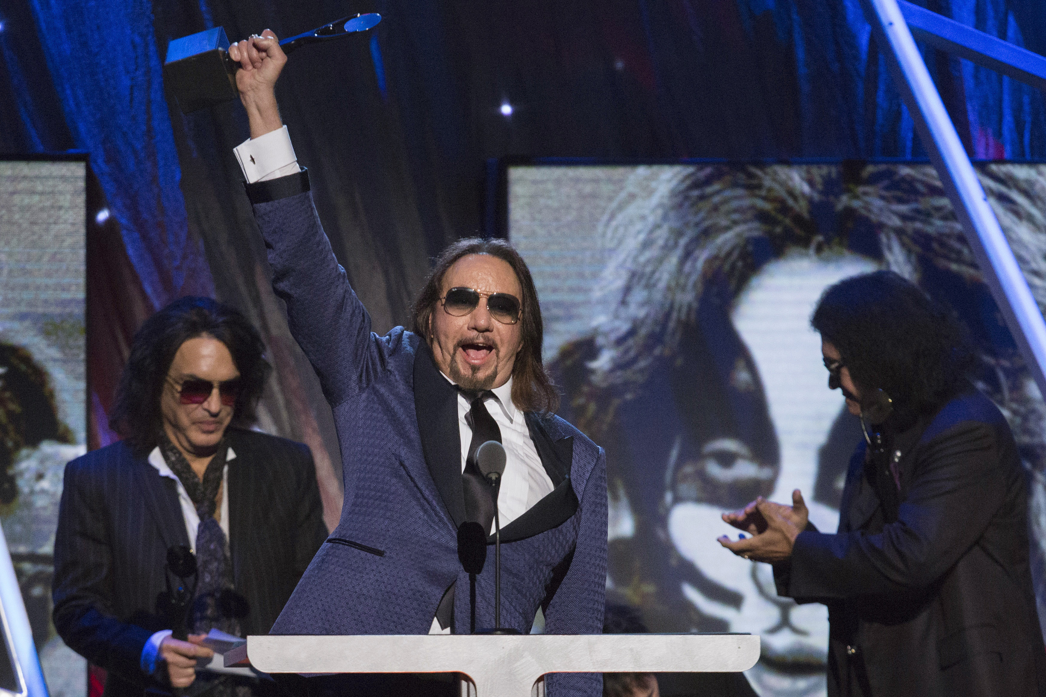 Ace Frehley of the band Kiss holds up their award after rock band was inducted at 29th annual Rock and Roll Hall of Fame Induction Ceremony in Brooklyn, New York