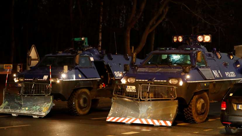 Armoured police vehicles are seen near the Brandenburg Gate ahead of New Year's Eve celebrations in Berlin