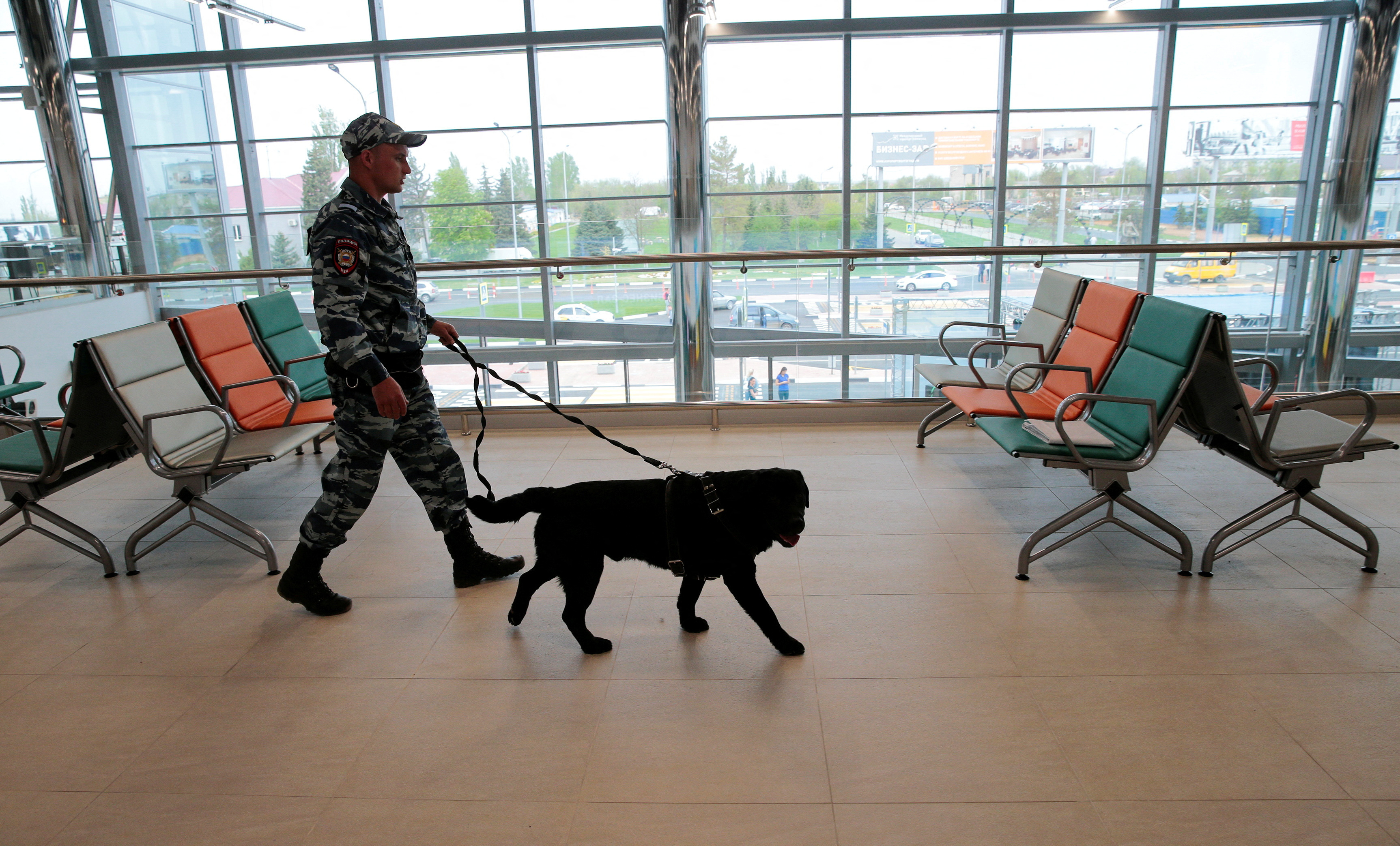 FILE PHOTO: A policeman with a dog walks at Volgograd International Airport