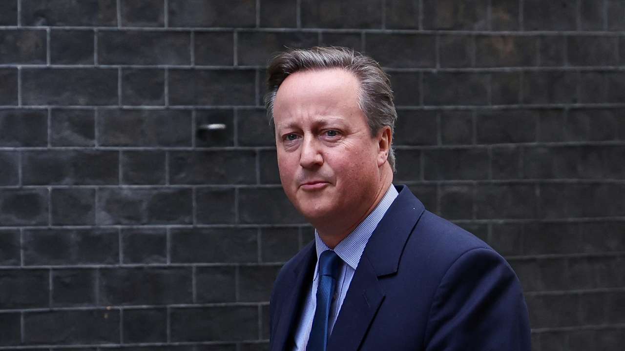 Former British Prime Minister David Cameron walks outside 10 Downing Street in London