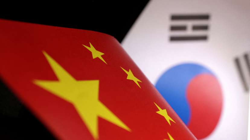Illustration shows printed Chinese and South Korean flags