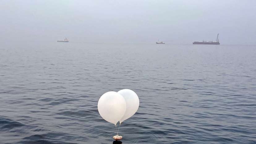 A balloon carrying various objects including what appeared to be trash, believed to have been sent by North Korea, is pictured at the sea off Incheon