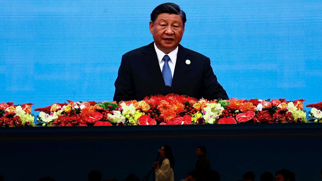 Journalists watch a giant screen broadcasting footage of Chinese President Xi Jinping at the opening ceremony of BRF in Beijing